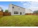 Expansive backyard with a lush lawn, wooden fence, and the back of the house at 4212 Auburn Hills Dr, Raleigh, NC 27616