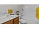 Bright bathroom featuring a white tub and shower combination, modern sink with wooden cabinets, and attractive decor at 4212 Auburn Hills Dr, Raleigh, NC 27616
