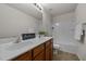 Well-lit bathroom features a double vanity and shower-tub combination at 4212 Auburn Hills Dr, Raleigh, NC 27616