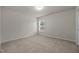 Neutral bedroom with cozy carpeting and a bright window at 4212 Auburn Hills Dr, Raleigh, NC 27616