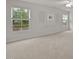 Bright bedroom featuring neutral carpet, large windows with blinds, and modern wall decor at 4212 Auburn Hills Dr, Raleigh, NC 27616