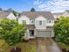 A charming two-story home with a stone accents, an attached two-car garage, and mature landscaping at 4212 Auburn Hills Dr, Raleigh, NC 27616