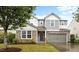 Charming two-story home featuring stone accents, siding, a two-car garage and a welcoming green front door at 4212 Auburn Hills Dr, Raleigh, NC 27616