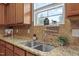 Kitchen featuring granite countertops, stainless steel sink, and tiled backsplash at 4212 Auburn Hills Dr, Raleigh, NC 27616