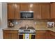Kitchen featuring granite countertops, stainless appliances, and wood cabinets at 4212 Auburn Hills Dr, Raleigh, NC 27616