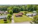 An aerial view of a home with lush greenery, a well-maintained lawn, and a quiet neighborhood at 424 Camp Rd, Burlington, NC 27217