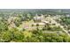 Aerial perspective capturing houses, trees, a school building and buses in a residential neighborhood at 424 Camp Rd, Burlington, NC 27217