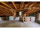 Large attic with exposed wooden beams, a window, and ample space for storage or conversion at 424 Camp Rd, Burlington, NC 27217