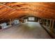 Large attic with exposed wooden beams, a window, and ample space for storage or conversion at 424 Camp Rd, Burlington, NC 27217