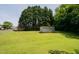 Expansive backyard with shed and mature trees, offering a private and peaceful retreat at 424 Camp Rd, Burlington, NC 27217