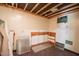 Unfinished basement space with exposed ceiling beams and potential for customization at 424 Camp Rd, Burlington, NC 27217