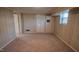 Finished basement area with storage cabinets and carpet, perfect for versatile use at 424 Camp Rd, Burlington, NC 27217