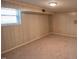 Functional basement area with a small window and carpet flooring at 424 Camp Rd, Burlington, NC 27217