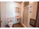 Functional bathroom with classic pink fixtures and a shower stall. Sold as-is at 424 Camp Rd, Burlington, NC 27217