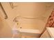 Bright bathroom featuring a shower-tub combo with safety bars and updated fixtures at 424 Camp Rd, Burlington, NC 27217