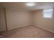 Bedroom with tan carpet, white walls, and a single window at 424 Camp Rd, Burlington, NC 27217