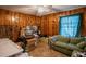 Bright bedroom featuring wood paneling, a ceiling fan and ample natural light at 424 Camp Rd, Burlington, NC 27217