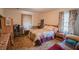 Cozy bedroom features a charming quilt bedspread, natural light, and comfortable furnishings at 424 Camp Rd, Burlington, NC 27217
