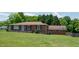 Brick home with a neat lawn, showing the side garage and back of the property at 424 Camp Rd, Burlington, NC 27217