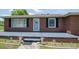 Close up of a cozy brick home entrance with landscaping and a cute front porch at 424 Camp Rd, Burlington, NC 27217