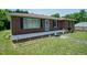 Charming brick home with a cozy front porch, decorative lawn ornaments, and a well-manicured lawn at 424 Camp Rd, Burlington, NC 27217