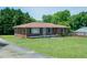 Brick home with an inviting front porch and landscaping, perfect for curb appeal at 424 Camp Rd, Burlington, NC 27217