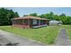Well-kept brick home featuring a quaint front porch and a lush green lawn at 424 Camp Rd, Burlington, NC 27217