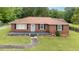 Charming one story brick home with a well-maintained lawn and inviting front porch at 424 Camp Rd, Burlington, NC 27217