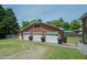 Spacious three-car garage with brick facade, complementing the home's design, and a full side entry door at 424 Camp Rd, Burlington, NC 27217