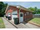 Attached three-car garage featuring durable brick construction and a convenient side entrance at 424 Camp Rd, Burlington, NC 27217