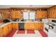 Well-lit kitchen featuring classic wood cabinets and modern appliances, offering a practical cooking space at 424 Camp Rd, Burlington, NC 27217