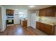 Functional kitchen with wooden cabinets, white appliances, and a window for natural light at 424 Camp Rd, Burlington, NC 27217