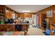 Cozy eat-in kitchen features wood paneling, ample cabinetry, and a breakfast bar for casual dining at 424 Camp Rd, Burlington, NC 27217