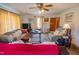 Inviting living room featuring a ceiling fan, ample seating, and cozy decor at 424 Camp Rd, Burlington, NC 27217