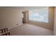 Living room with a large bright window, neutral walls, and carpet flooring at 424 Camp Rd, Burlington, NC 27217