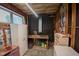 Interior view of unfinished workshop with sink, shelving units, and small windows at 424 Camp Rd, Burlington, NC 27217