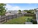 Fenced backyard featuring green grass, mature trees, and a garden, perfect for outdoor enjoyment at 4408 Jordan Oaks Way, Raleigh, NC 27604