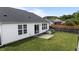 Cozy backyard featuring a manicured lawn, privacy fence, garden plot, and sliding glass door access at 4408 Jordan Oaks Way, Raleigh, NC 27604
