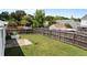 Spacious fenced backyard with healthy grass, metal planter, and concrete patio area at 4408 Jordan Oaks Way, Raleigh, NC 27604