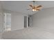 Spacious bedroom with neutral carpet, fan, and multiple access doors to ensuite at 4408 Jordan Oaks Way, Raleigh, NC 27604