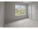 Bedroom features neutral carpet, a double door closet, and a window overlooking the yard at 4408 Jordan Oaks Way, Raleigh, NC 27604