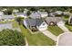 Aerial view of the home showing well-kept front lawn, driveway, and mature shade tree at 4408 Jordan Oaks Way, Raleigh, NC 27604