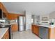 View of kitchen with a stainless steel refrigerator, tile floors and access to living room at 4408 Jordan Oaks Way, Raleigh, NC 27604