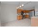 Well-lit kitchen featuring stainless steel appliances, tile floors, and natural wood cabinets at 4408 Jordan Oaks Way, Raleigh, NC 27604