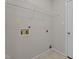 Functional laundry area with utility connections, overhead shelving, and easy access to outdoors at 4408 Jordan Oaks Way, Raleigh, NC 27604