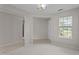 Bright and airy living room featuring neutral paint, carpet, and a large window at 4408 Jordan Oaks Way, Raleigh, NC 27604