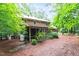 Brick home boasting a screened-in porch nestled amongst lush trees and greenery at 4521 Chicopee Trl, Durham, NC 27707