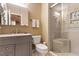 Well-lit bathroom featuring a vanity, toilet, and shower with glass doors at 4521 Chicopee Trl, Durham, NC 27707