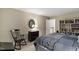 Bedroom with a rocking chair, dresser with a mirror, and a bookshelf at 4521 Chicopee Trl, Durham, NC 27707