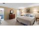 Bright bedroom featuring a bed with decorative pillows, a wood dresser, and an adjoining bathroom at 4521 Chicopee Trl, Durham, NC 27707